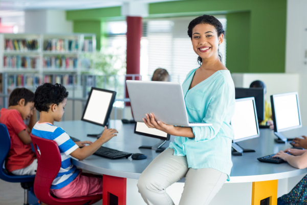 A teacher with laptop and happy face